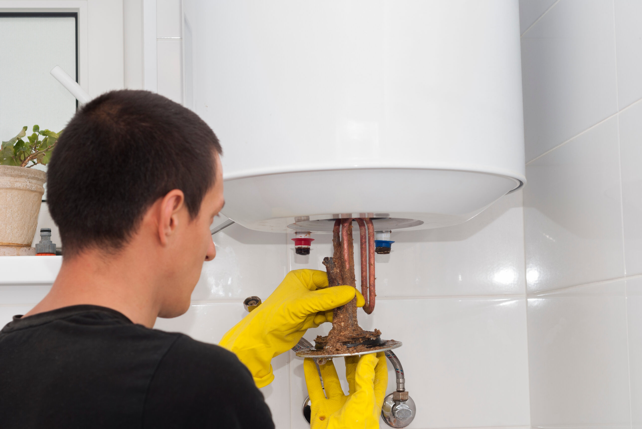 installer removing component from boiler during boiler installation