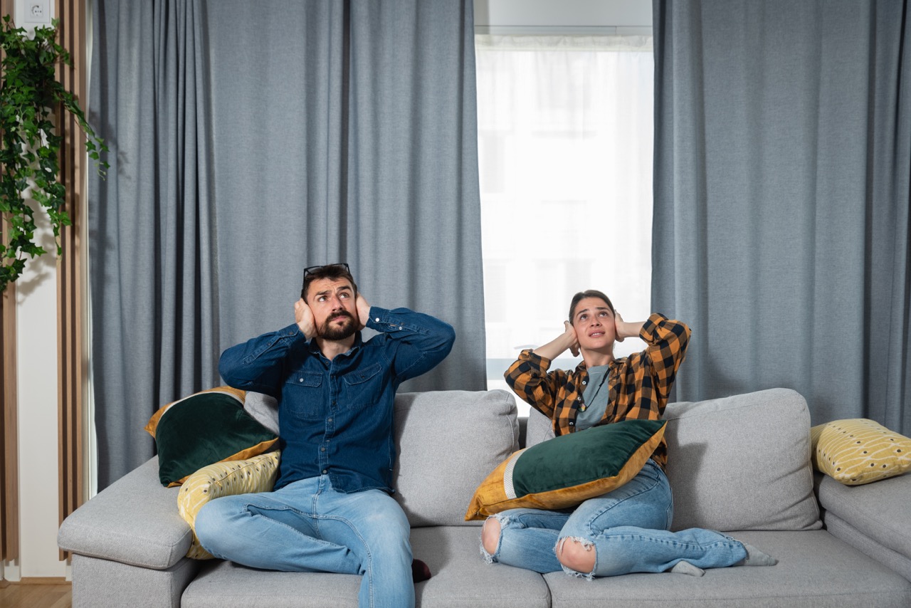 Couple covering their ears