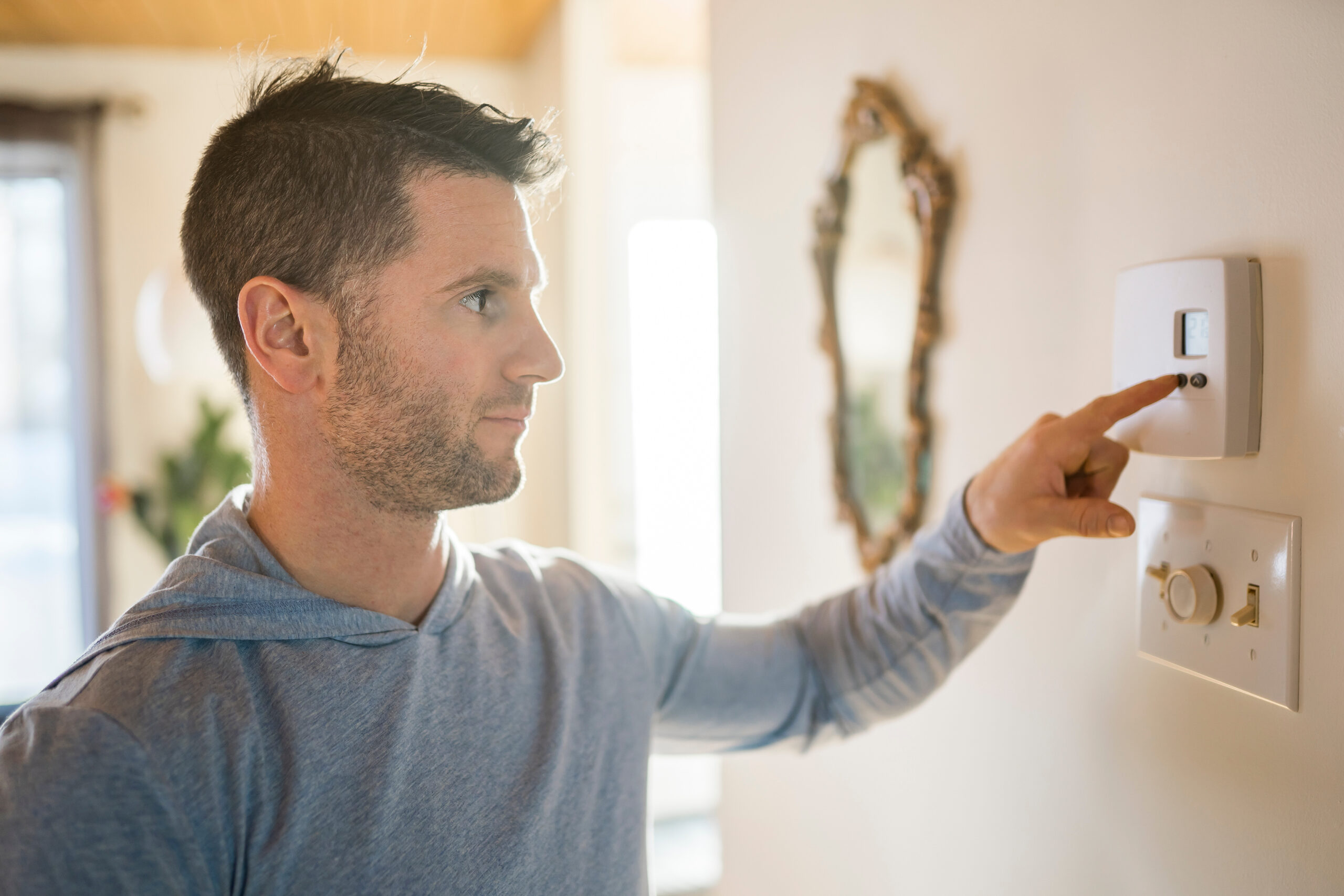 Man adjusting the thermostat