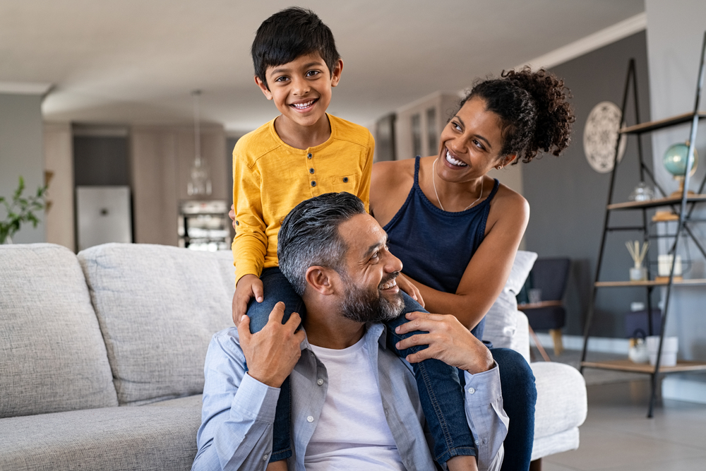 a son sits on his fathers shoulders as the spend a moment together with their wife and mother in Mason, OH after having an new ac system installed